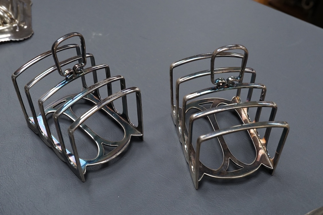 A pair of George V silver five bar toast racks, by Atkin Brothers, Sheffield, 1912, length 94mm, together with a silver muffin dish lid and a silver pedestal bonbon dish, 26.2ox
